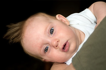 Image showing An almost four month old baby girl on daddy's arm