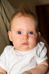 Image showing An almost four month old baby girl on daddy's arm