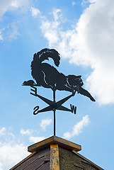 Image showing Weather vane on background of blue sky and clouds.