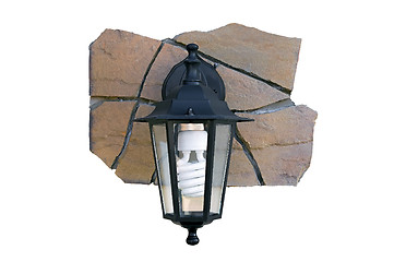 Image showing Street light on a fragment of a stone wall.