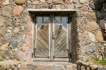 Image showing horseshoe hang over stone wall wooden door  