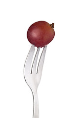 Image showing Red Globe grape held by a fork