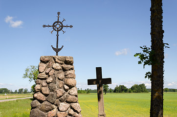 Image showing stone monument with metal squirm cross in nature  