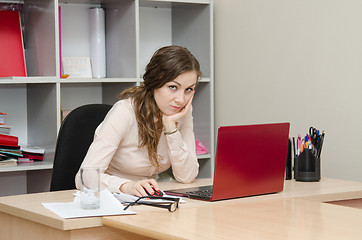 Image showing Tired girl on a workplace at office