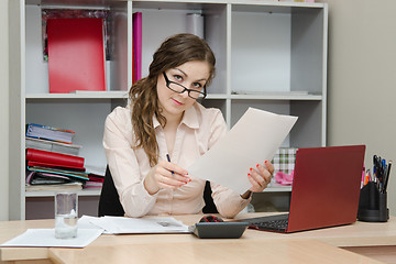 Image showing Business office girl reading a document