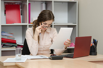 Image showing Girl reading a document in the workplace