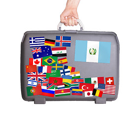 Image showing Used plastic suitcase with stickers