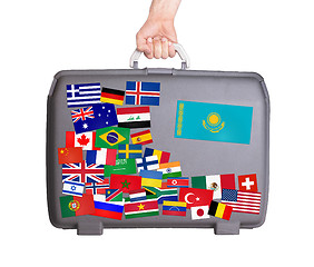 Image showing Used plastic suitcase with stickers