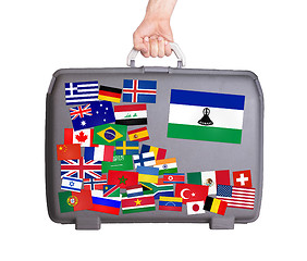 Image showing Used plastic suitcase with stickers