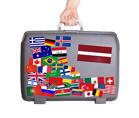 Image showing Used plastic suitcase with stickers