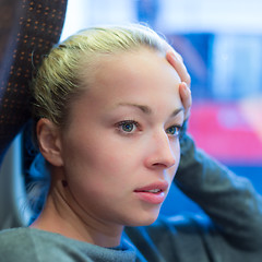 Image showing Woman looking out tram's window.