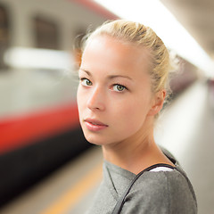 Image showing Young woman on platform of railway station.