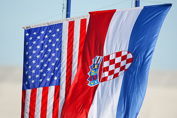 Image showing Croatian and American flags waving on white background