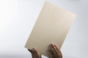 Image showing Plywood sign held up by young hands