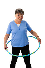 Image showing Senior woman exercising with hula-hoop