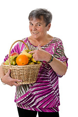 Image showing Senior woman presenting fruit