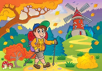 Image showing Hiker walking on path near windmill