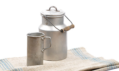 Image showing Graduated jug and milk can