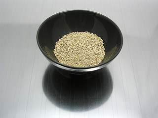 Image showing Bowl of chinaware with sesame on reflecting matting