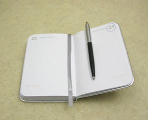 Image showing To flip an appointment calendar open with ball pen