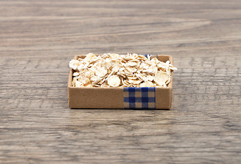 Image showing Oat flakes on wood