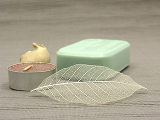 Image showing Green soap with decoration articles on a  gray  background