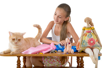 Image showing The girl sews toys from fabric