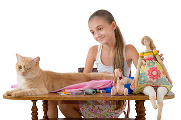 Image showing The girl sews toys from fabric