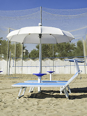 Image showing Sunbeds and umbrellas on the beach