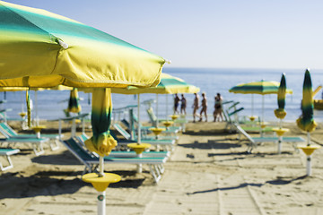 Image showing Sunbeds and umbrellas on the beach