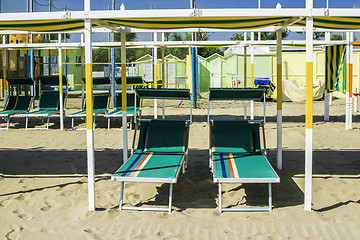 Image showing Sunbeds and umbrellas on the beach