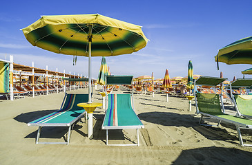 Image showing Sunbeds and umbrellas on the beach