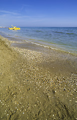 Image showing Yellow lifeboat on the beach.