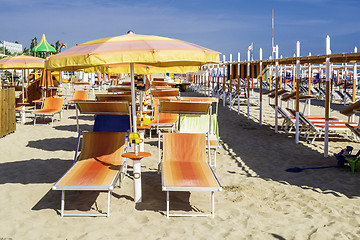 Image showing Sunbeds and umbrellas on the beach