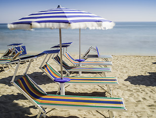 Image showing Sunbeds and umbrellas on the beach