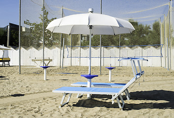 Image showing Sunbeds and umbrellas on the beach