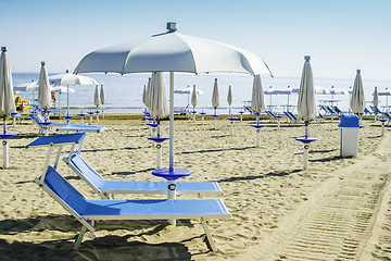 Image showing Sunbeds and umbrellas on the beach