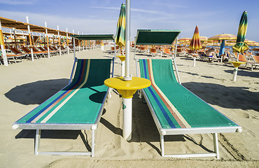 Image showing Sunbeds and umbrellas on the beach