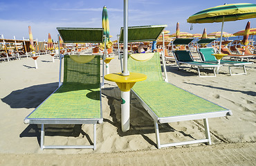 Image showing Sunbeds and umbrellas on the beach