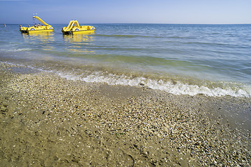 Image showing Yellow lifeboat on the beach.