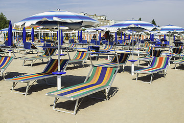 Image showing Sunbeds and umbrellas on the beach