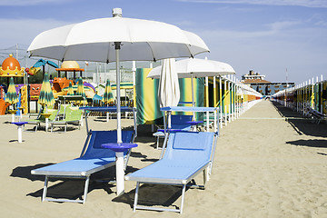 Image showing Sunbeds and umbrellas on the beach