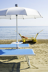 Image showing Sunbeds and umbrellas on the beach