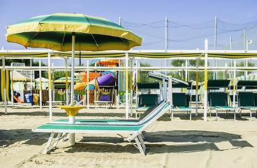 Image showing Sunbeds and umbrellas on the beach