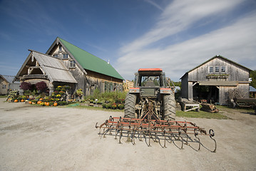 Image showing tractor tiller in front of garden center in rural vermont
