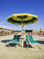 Image showing Sunbeds and umbrellas on the beach