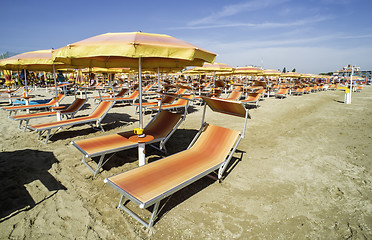 Image showing Sunbeds and umbrellas on the beach