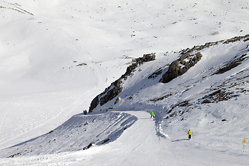 Image showing Snowboarders and skiers on groomed slope