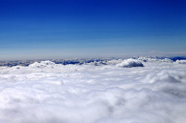 Image showing Mountains under clouds in sunny winter day