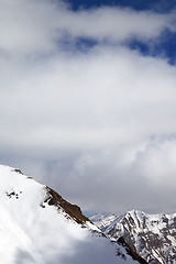 Image showing Snowy slope and sky with clouds at sun day